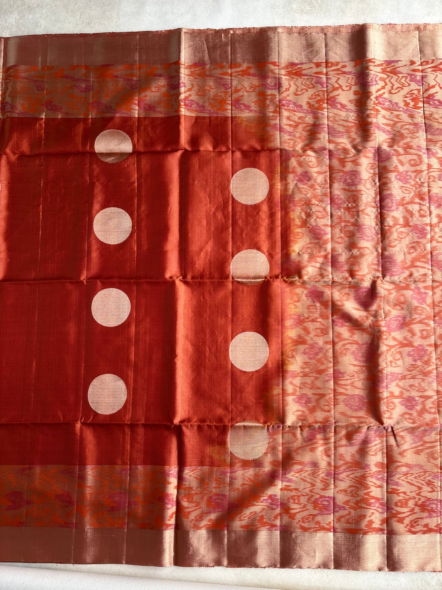 Rust Orange Silk Saree with Ikat-Inspired Weave and Statement Polka Motif